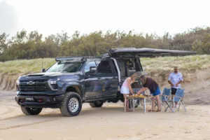 Chevrolet Silverado 2500 with Norweld Compact Deluxe Canopy and awning set up for a beach picni