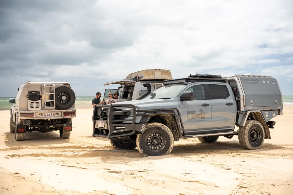 Ford Ranger Super Duty with Norweld canopy alongside other Norweld-equipped vehicles on the beach