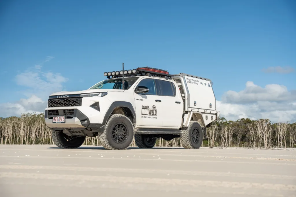 Toyota Hilux dual cab with Norweld canopy parked on the beach