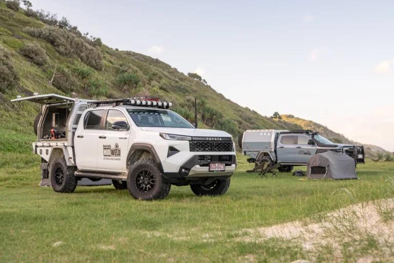 Toyota Hilux dual cab with Norweld canopy set up at a coastal campsite