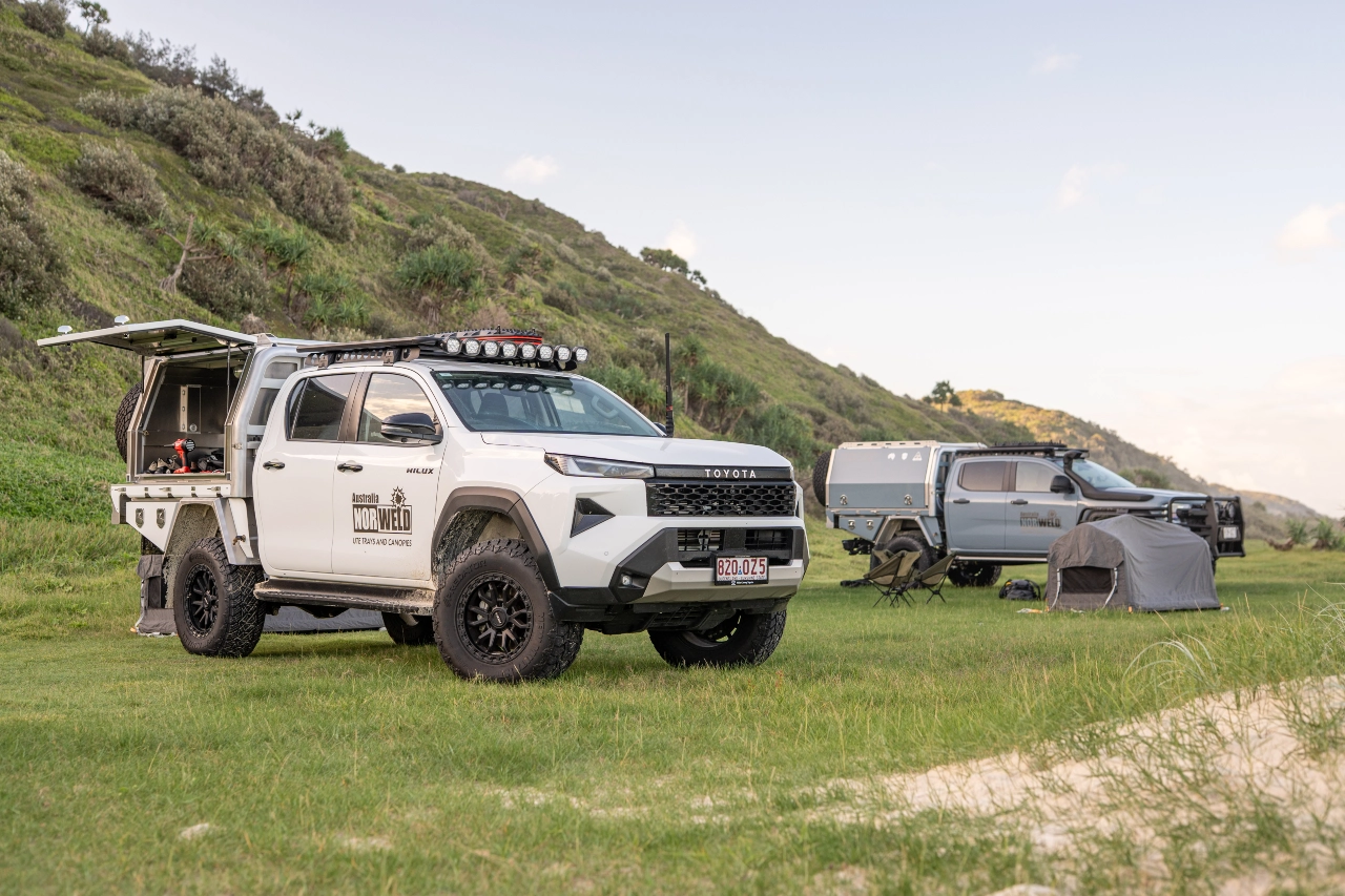 Toyota Hilux dual cab with Norweld canopy set up at a coastal campsite