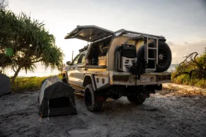 Toyota LandCruiser 79 Series with Norweld canopy set up for camping near the beach