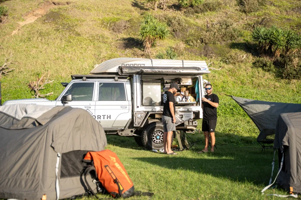 Toyota LandCruiser 79 Series with Norweld canopy and awning set up at a coastal campsite